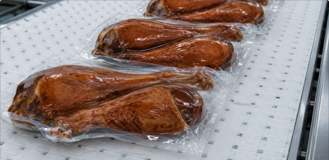 Packaged meat on a processing line